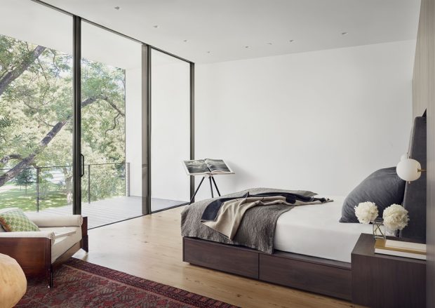 Bedroom with glass walls overlooking the view